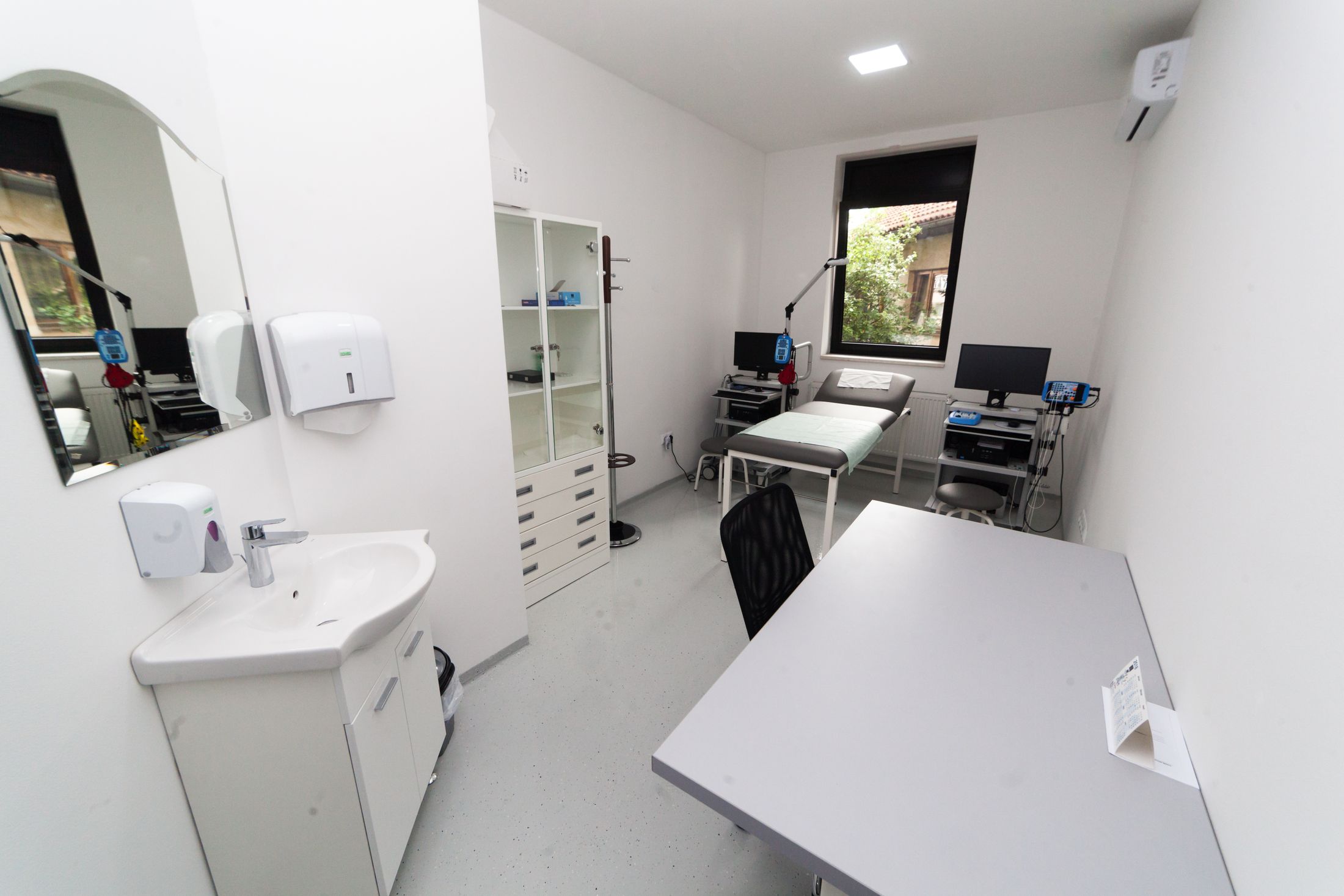 Medical consulting room with furniture and diagnostic equipment